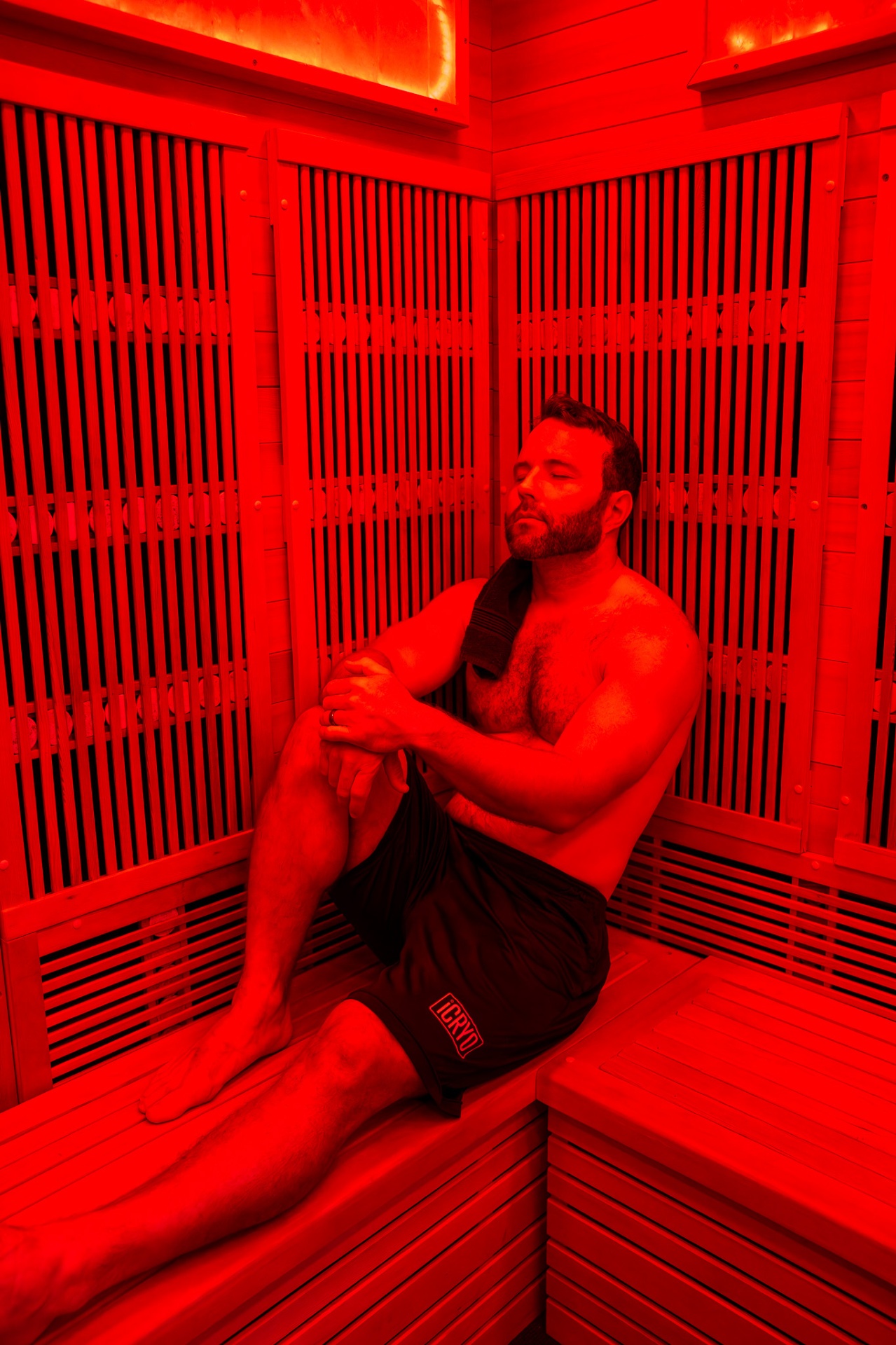 Guest relaxing inside a full-spectrum infrared sauna at iCRYO Helotes